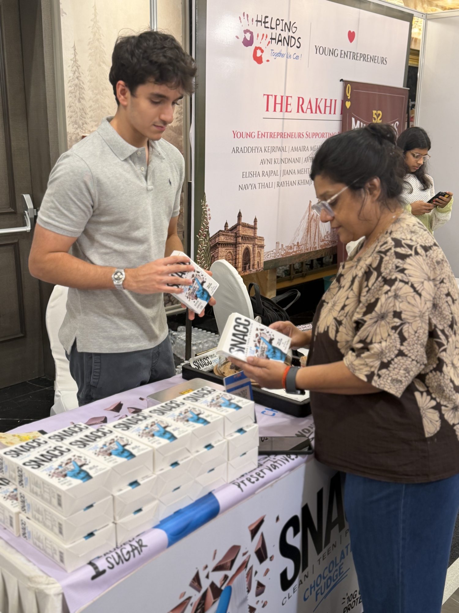 Rayhan at the SNACC stall, Helping Hands Exhibition #2